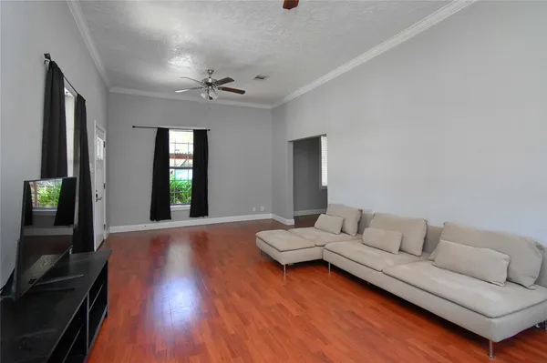 a view of a livingroom with wooden floor and a window