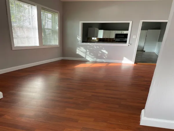 a kitchen with granite countertop a refrigerator and a stove top oven