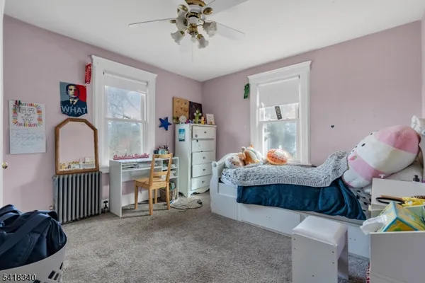 a bedroom with furniture and a window
