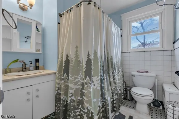 a white toilet sitting next to a bathroom sink