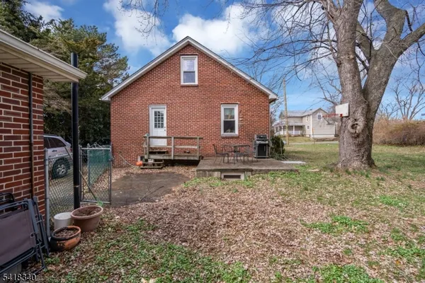 a backyard of a house with barbeque oven fire pit table and chairs