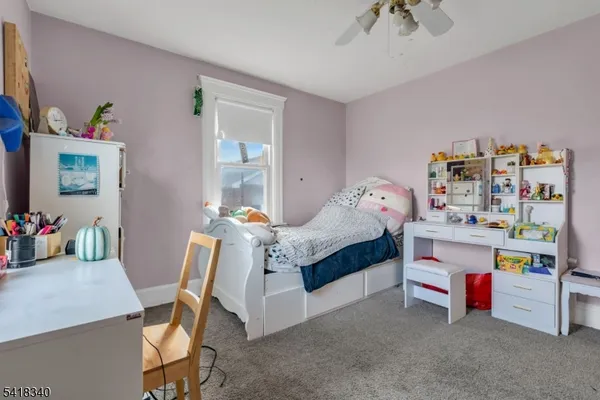 a bedroom with a bed and a desk