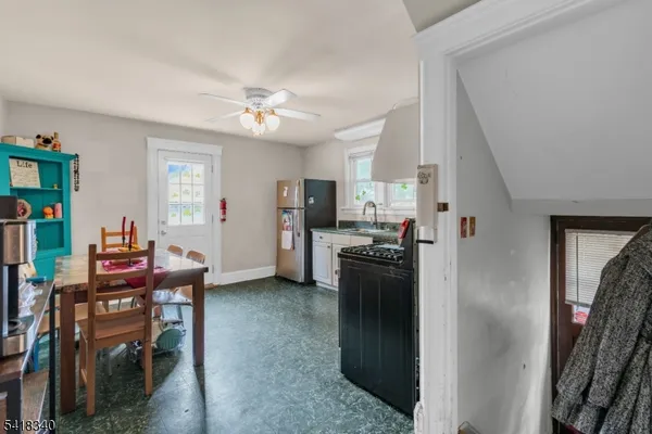 a view of a kitchen with refrigerator and dining table