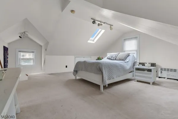 a spacious bedroom with a bed and window