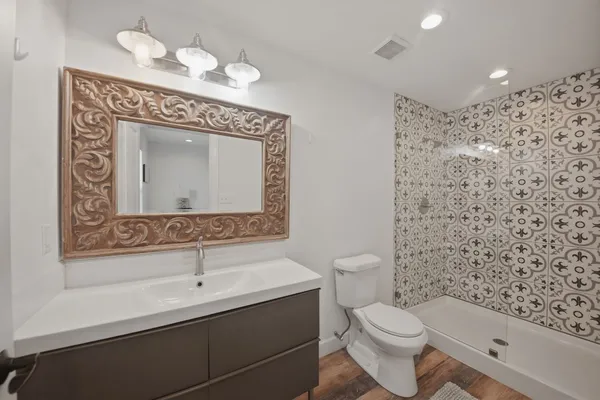 a bathroom with a toilet sink and mirror