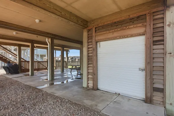 a view of a porch with a table and chairs