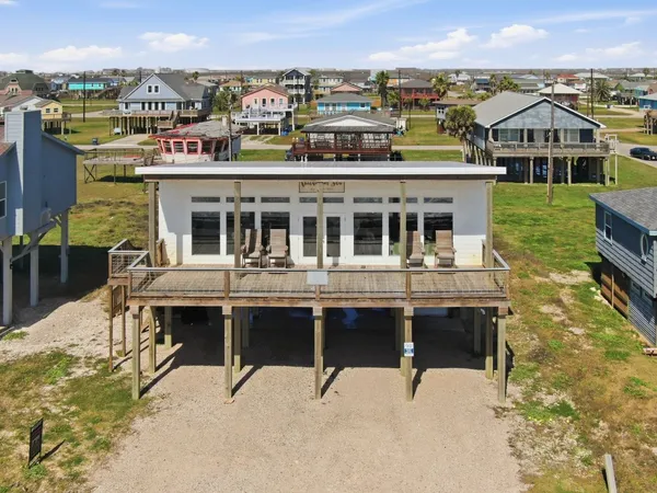 a front view of house with yard and outdoor seating