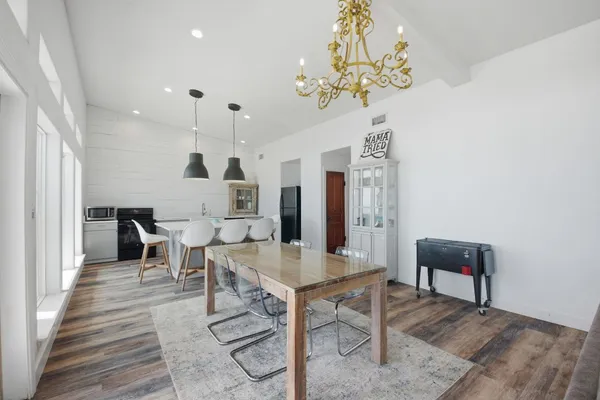 a view of a dining room with furniture and chandelier