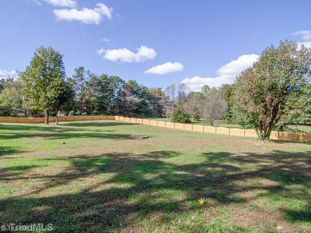 1250 Blackberry Ridge Drive High Point, NC 27265 - Photo 15 of 16 Exterior Back. This house is surrounded By Lots of Trees. Seller recently installed Fence around back yard!