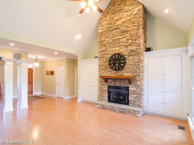 Living Room. Soaring Ceilings and Stacked Stone Fireplace Enhances this Living Area with Builti Ins