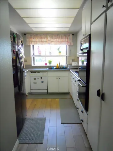 a kitchen with granite countertop cabinets and steel appliances