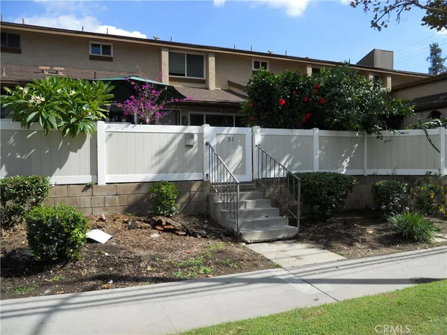 a view of a house with a yard and a patio