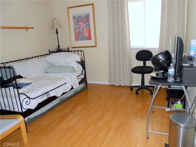 a bedroom with a bed and a dresser