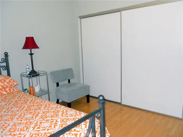 a bedroom with furniture and a flat screen tv