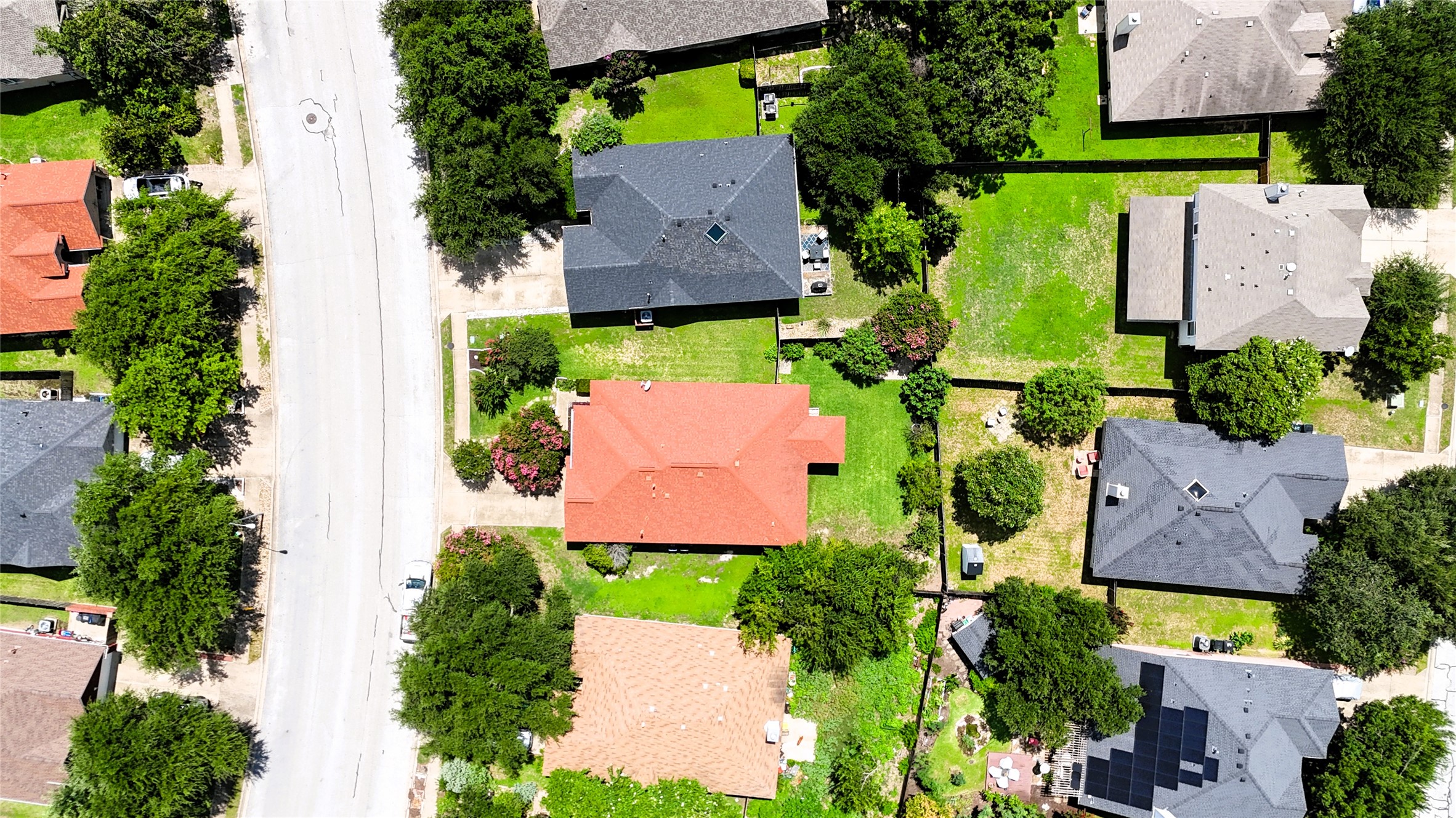 1108 Springbrook Road Pflugerville, TX 78660 - Photo 36 of 37 An aerial perspective reveals the residential community, showcasing neatly aligned homes amidst verdant lawns and mature trees.