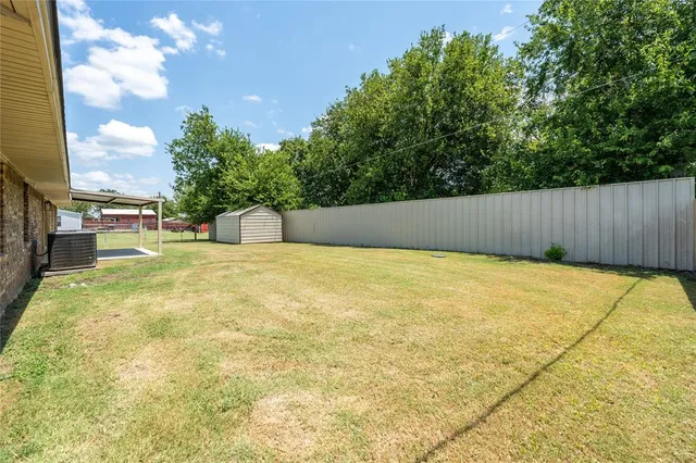 a swimming pool with trees in the background