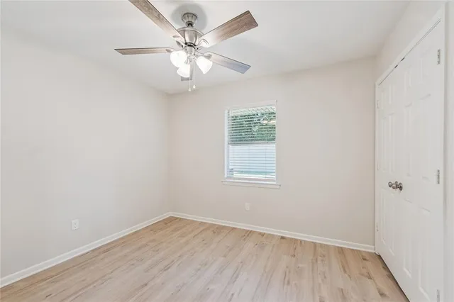 wooden floor in an empty room with a window