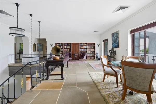 a living room with furniture and a floor to ceiling window