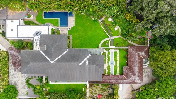 an aerial view of a house with garden space and street view