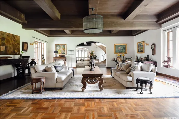 a living room with lots of furniture and a chandelier