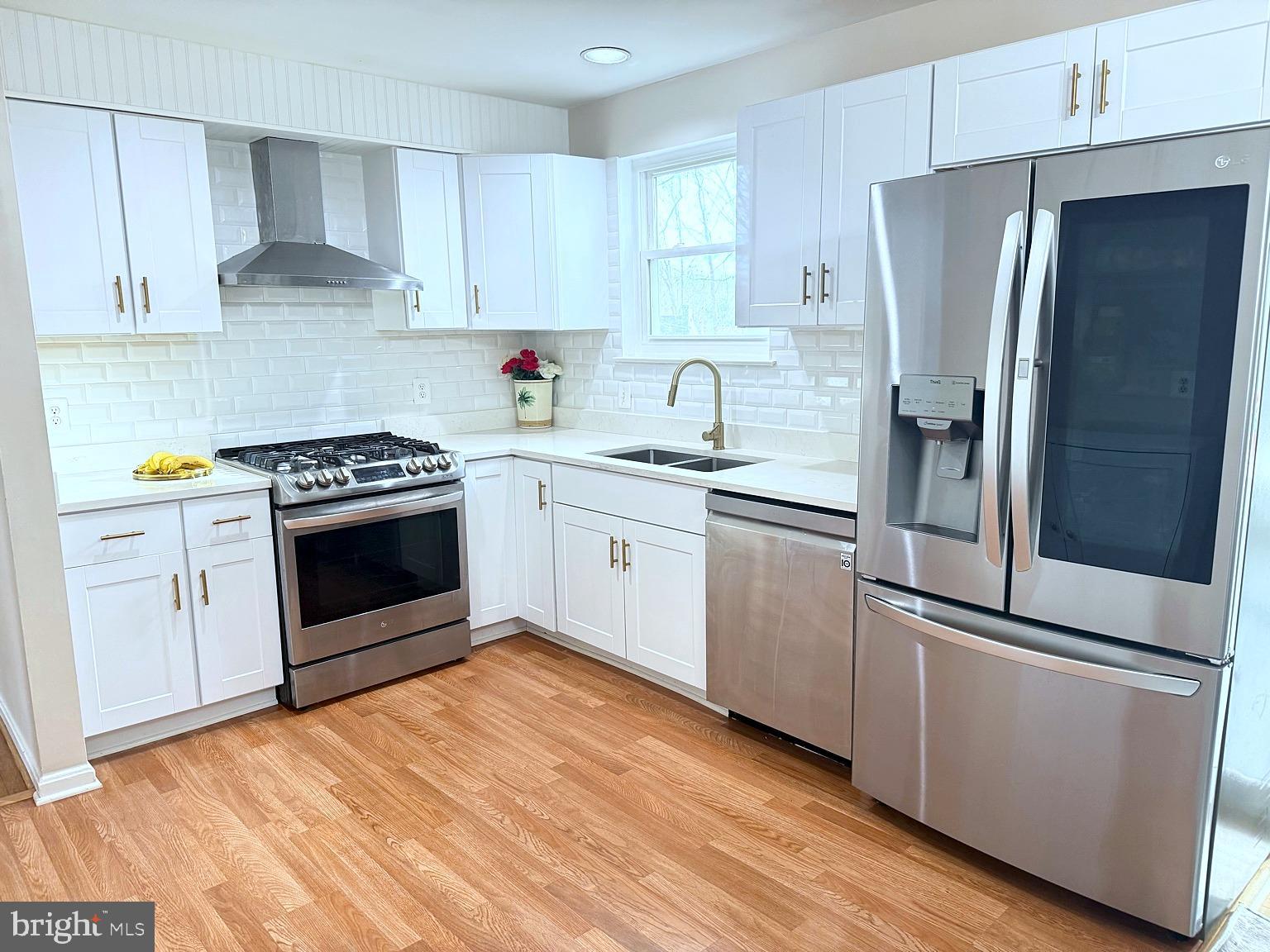8621 Kenilworth Drive Springfield, VA 22151 - Photo 7 of 21 a kitchen with stainless steel appliances white cabinets and a stove