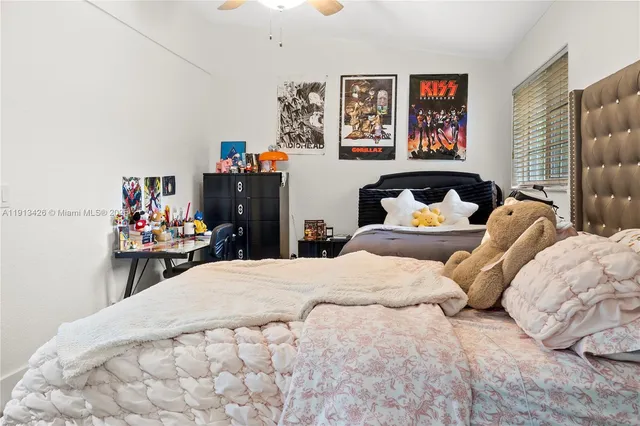 a bedroom with a bed and wall paintings