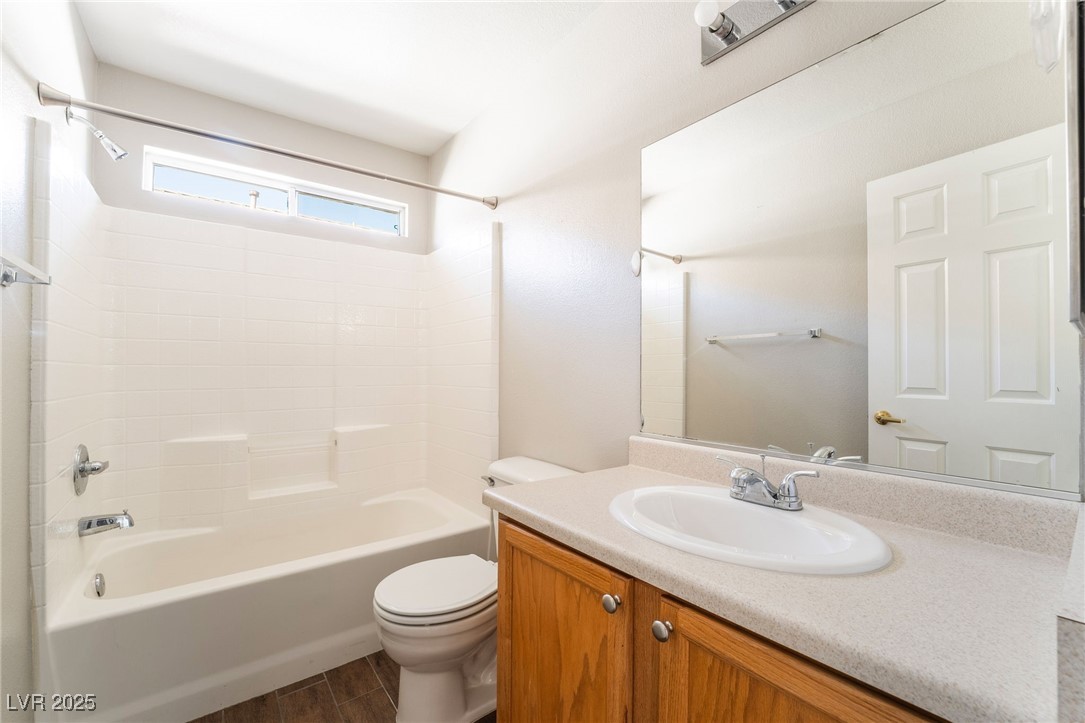 1570 Rusty Ridge Lane Henderson, NV 89002 - Photo 28 of 35 Bathroom with shower / bath combination, vanity, toilet, and wood finished floors
