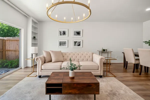 a living room with furniture a table and a potted plant