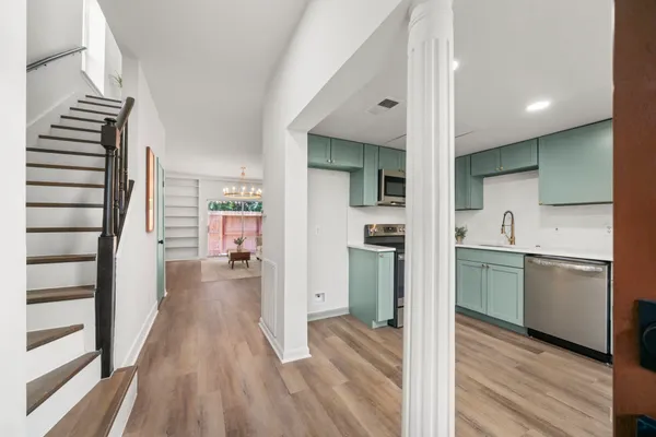 a kitchen with a refrigerator and a sink
