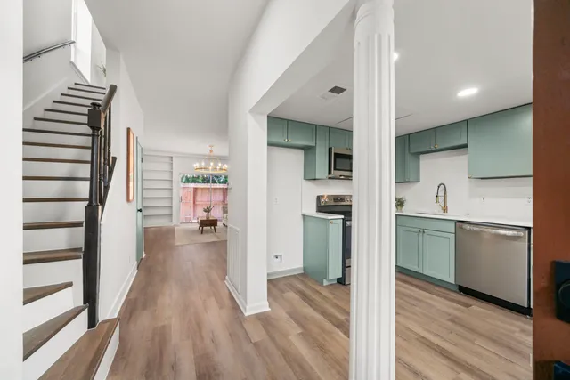 a kitchen with a refrigerator and a sink