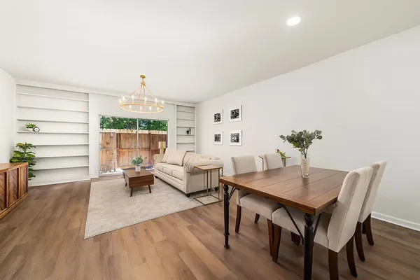 a view of a dining room with furniture and wooden floor