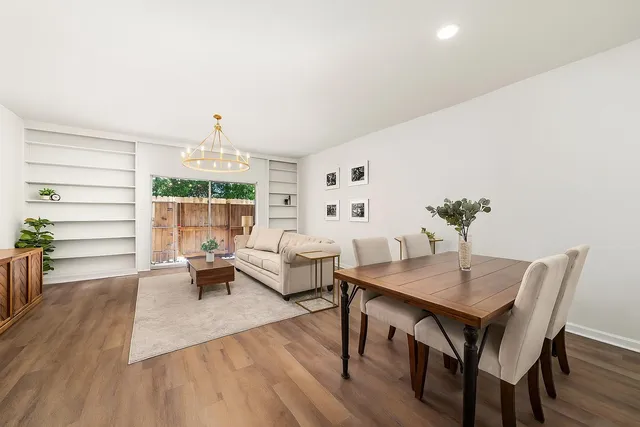 a view of a dining room with furniture and wooden floor