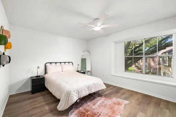 a bed sitting in a bedroom next to a window
