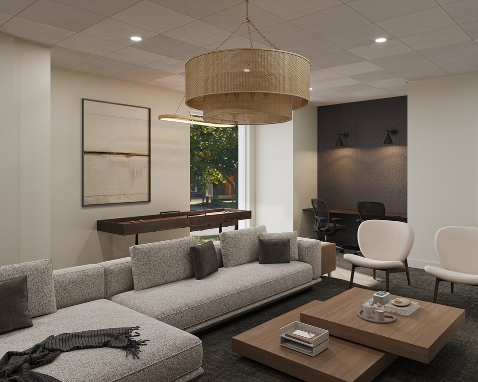 62 Foundry Street, Unit 407 Wakefield, MA 01880 - Photo 12 of 17 a living room with furniture and a lamp