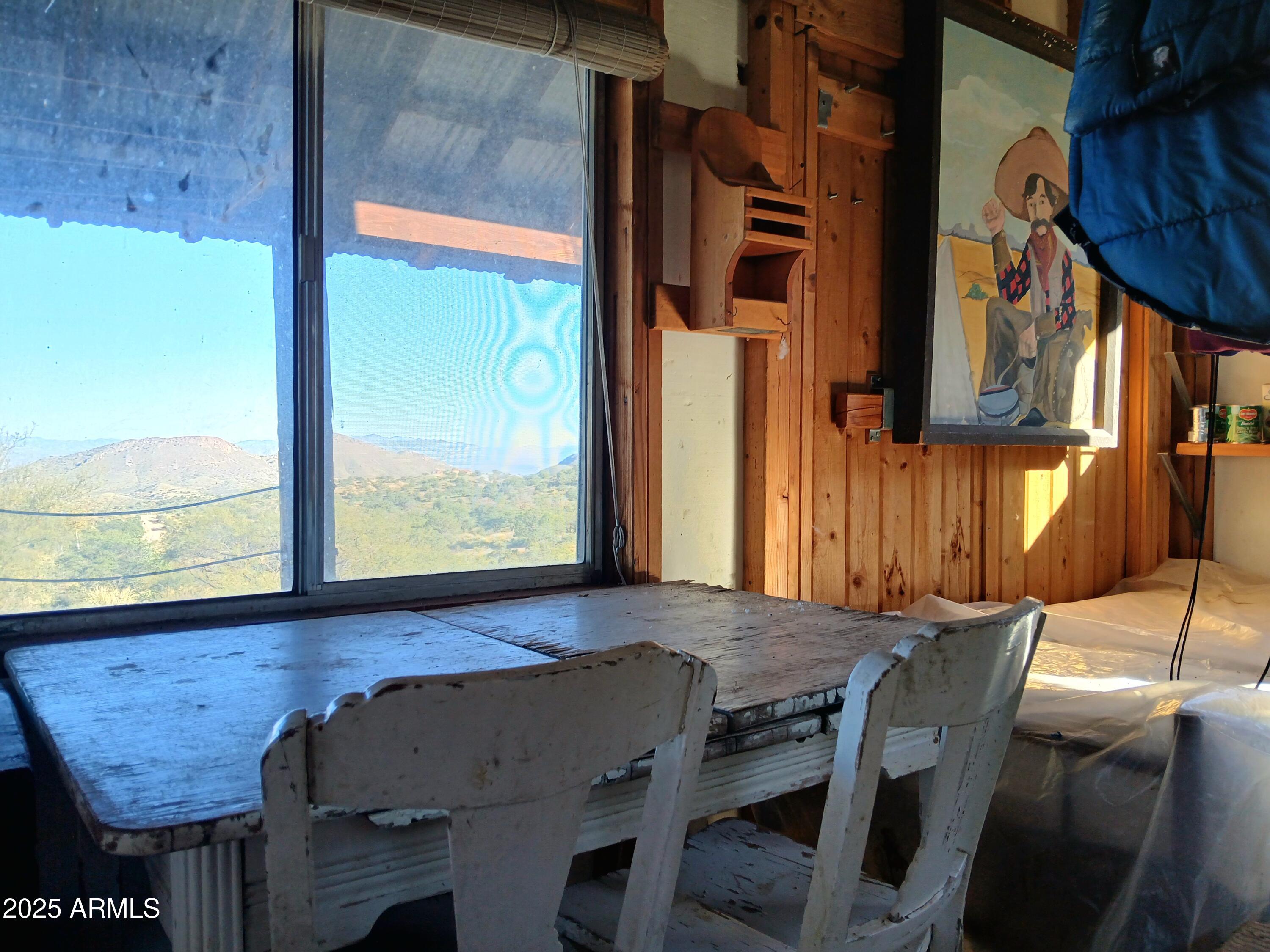 11699 North Last Chance Road Elfrida, AZ 85610 - Photo 12 of 39 a view of a dining room with furniture and a window