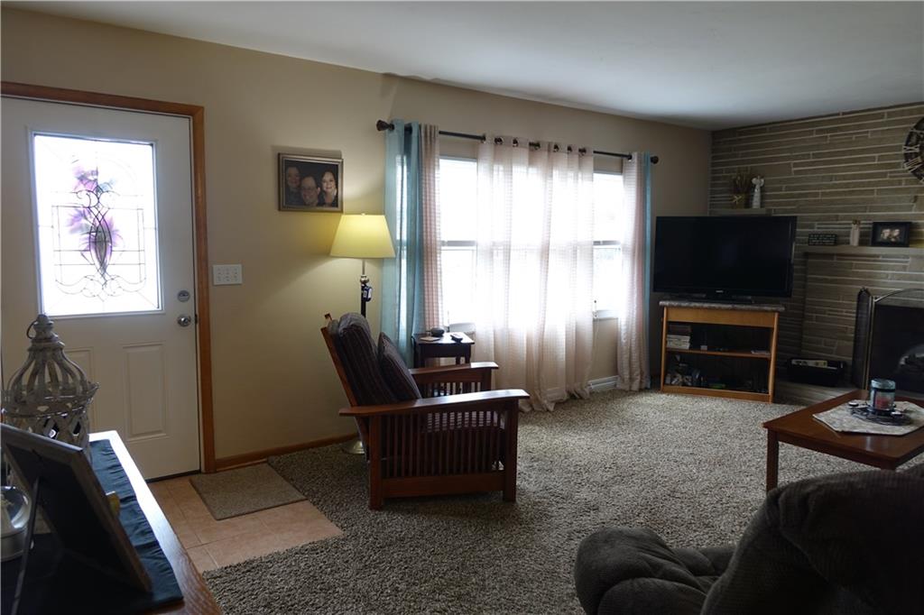 Spacious Living Room with Picture Window and Brick Fireplace