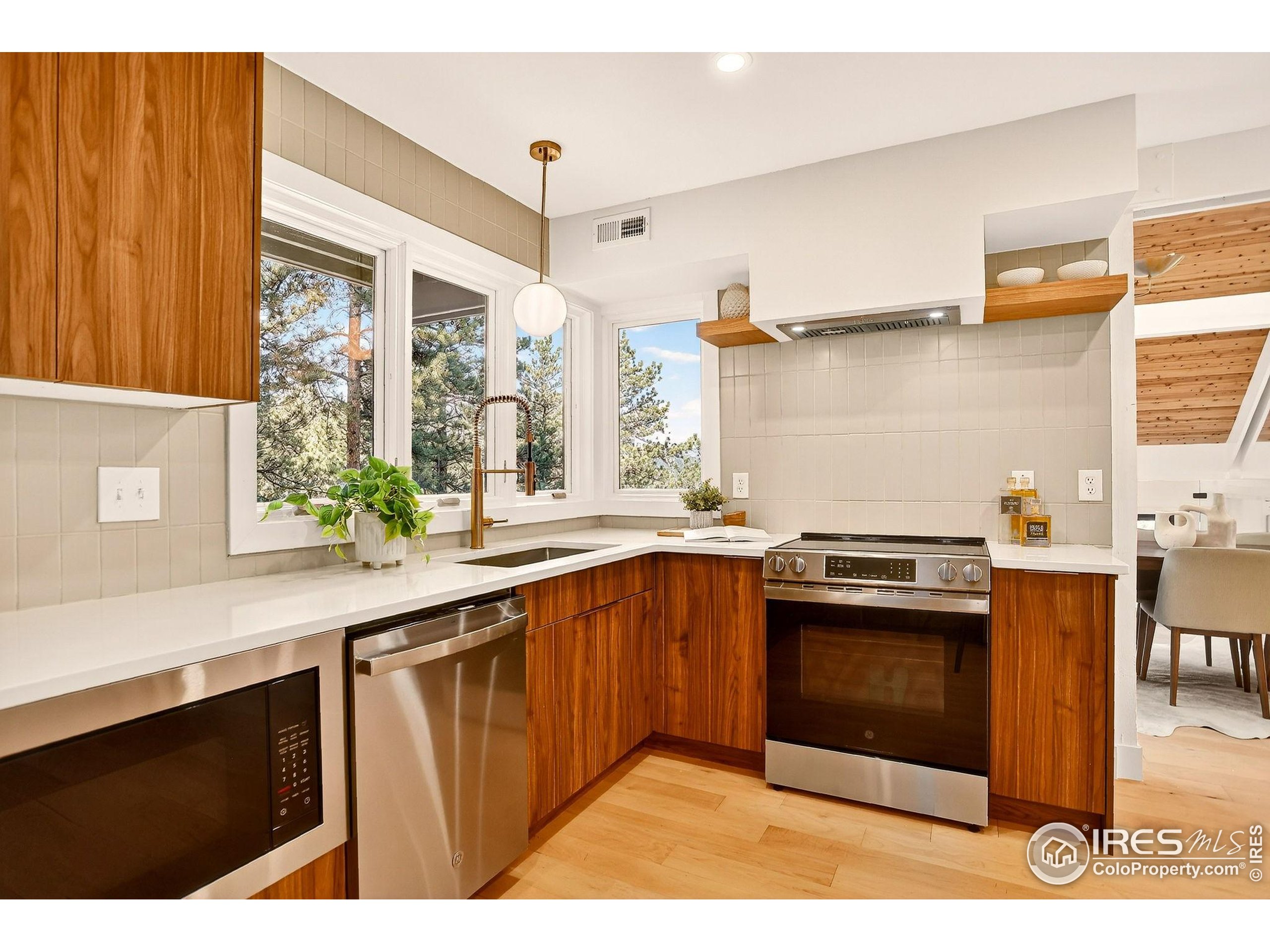 1138 Timber Lane Boulder, CO 80304 - Photo 11 of 21 a kitchen with stainless steel appliances granite countertop a stove a sink and a microwave