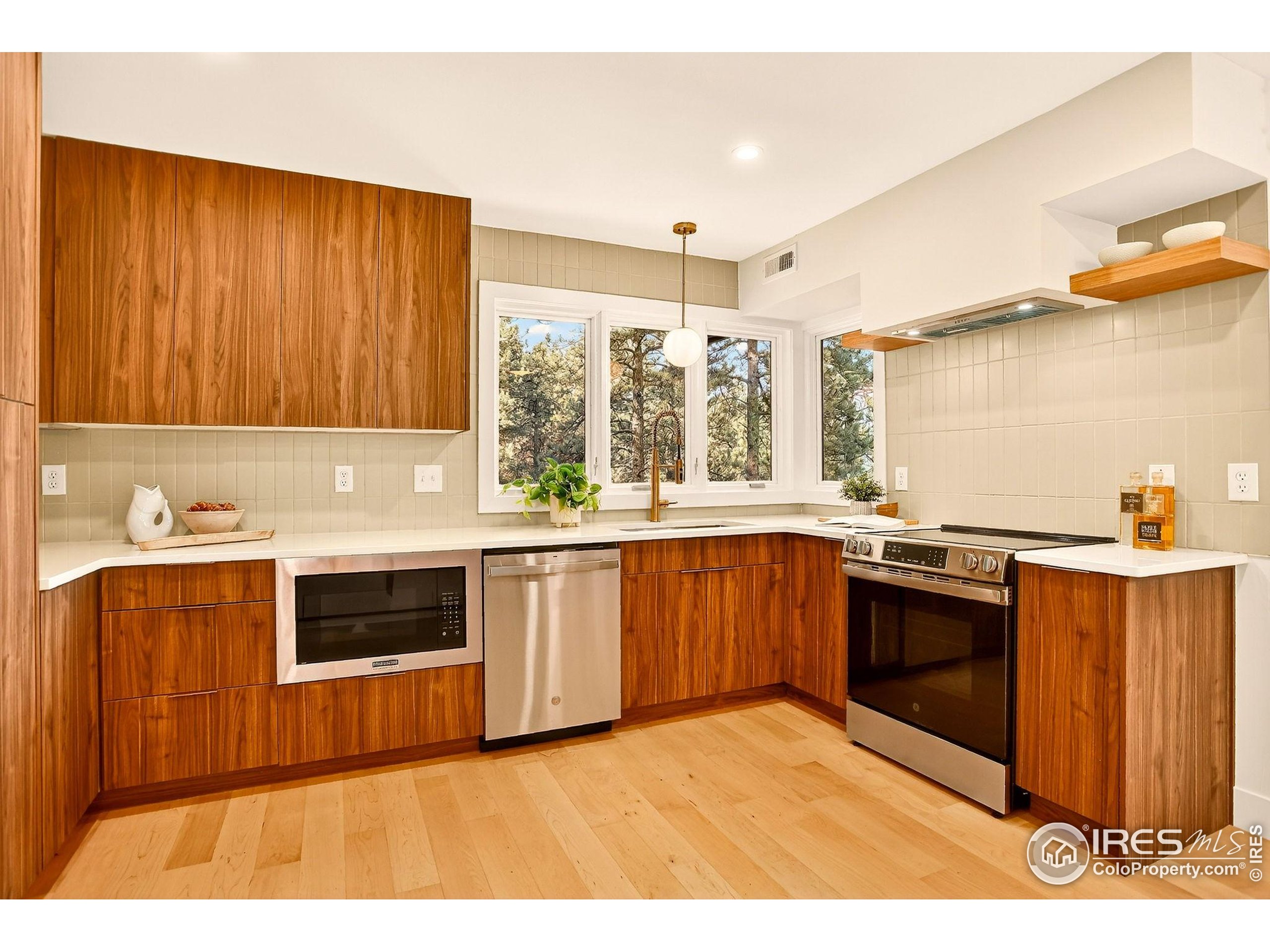 1138 Timber Lane Boulder, CO 80304 - Photo 3 of 21 a kitchen with stainless steel appliances granite countertop a stove a sink and a microwave