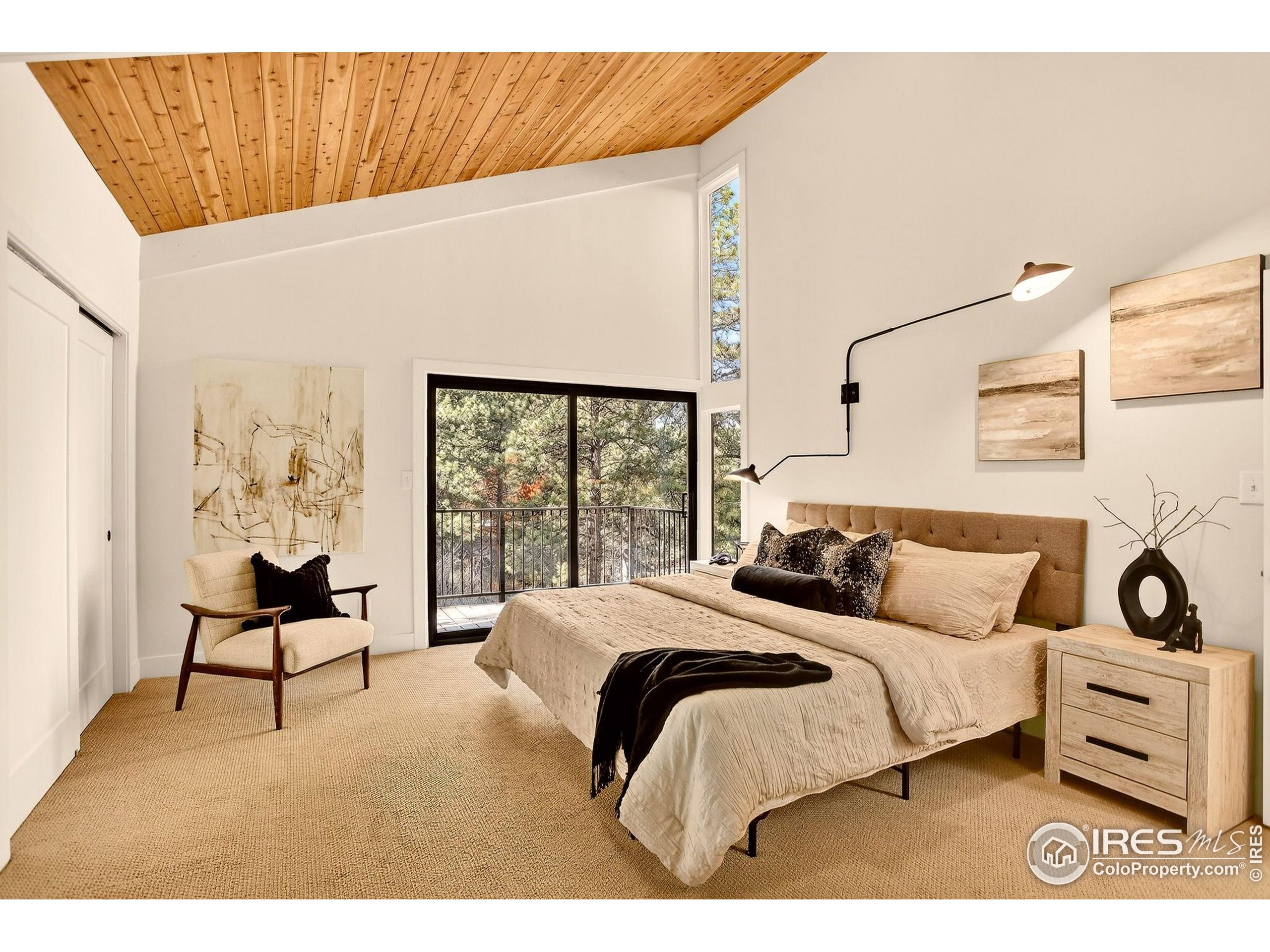 1138 Timber Lane Boulder, CO 80304 - Photo 5 of 21 a bedroom with a bed and a chair with the outer view