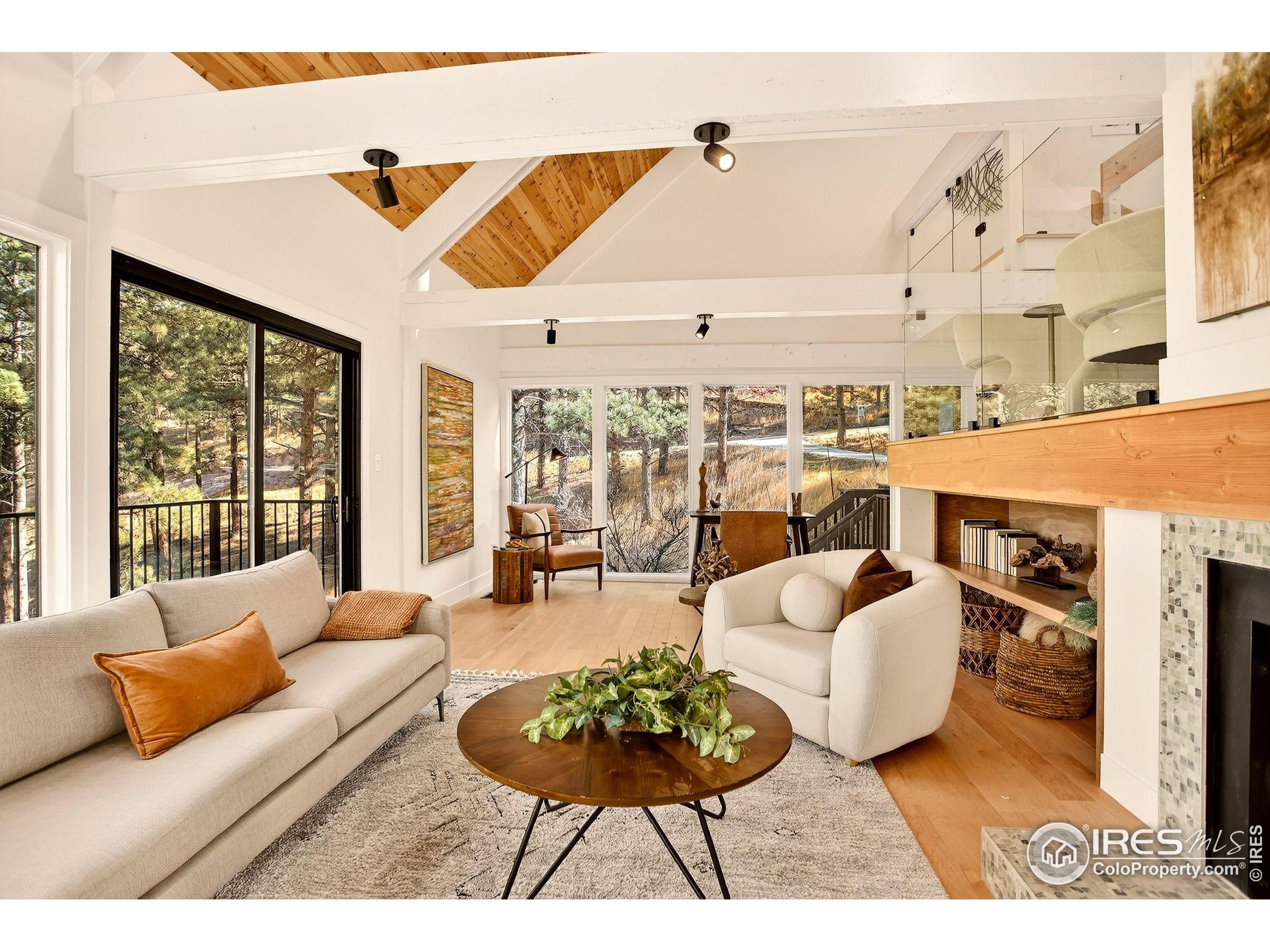 1138 Timber Lane Boulder, CO 80304 - Photo 8 of 21 a living room with furniture a chandelier and a floor to ceiling window