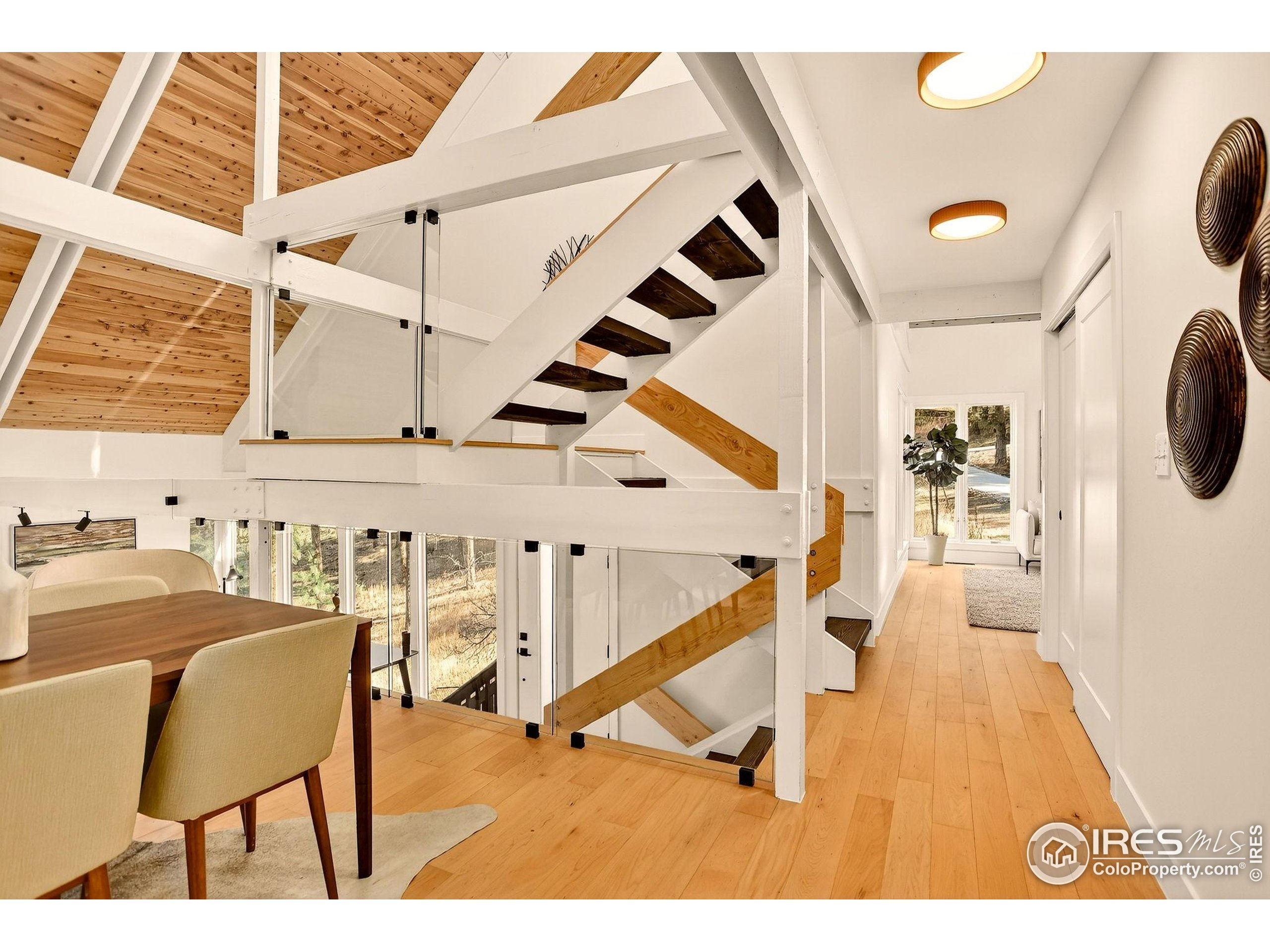 1138 Timber Lane Boulder, CO 80304 - Photo 10 of 21 a view of entryway dining room and hall with wooden floor