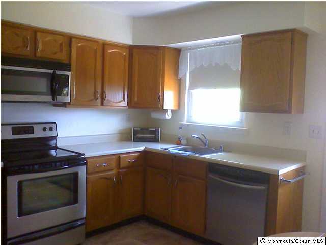 5A Alpine Road, Unit B Whiting, NJ 08759 - Photo 1 of 3 a kitchen with stainless steel appliances a stove a sink a microwave and cabinets