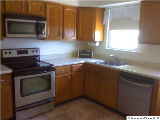 5A Alpine Road, Unit B Whiting, NJ 08759 - Photo 3 of 3 a kitchen with stainless steel appliances granite countertop a stove microwave and sink