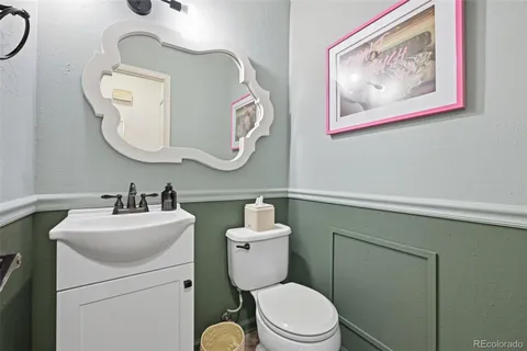 a bathroom with a toilet a sink and mirror