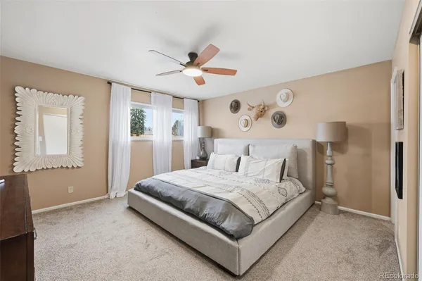 a bedroom with a large bed and a chandelier