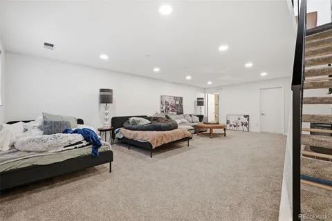 a spacious bedroom with a bed and a couch