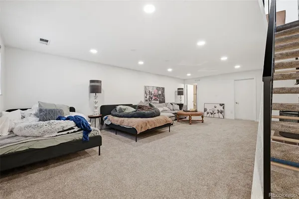 a spacious bedroom with a bed and a couch