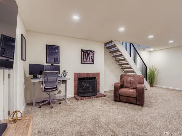 a livingroom with furniture and a fireplace