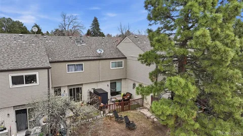 a aerial view of a house with a yard and sitting area