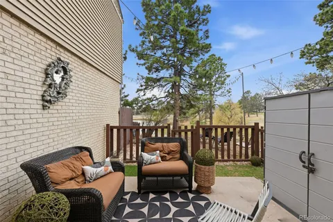a view of a patio with a table and chairs